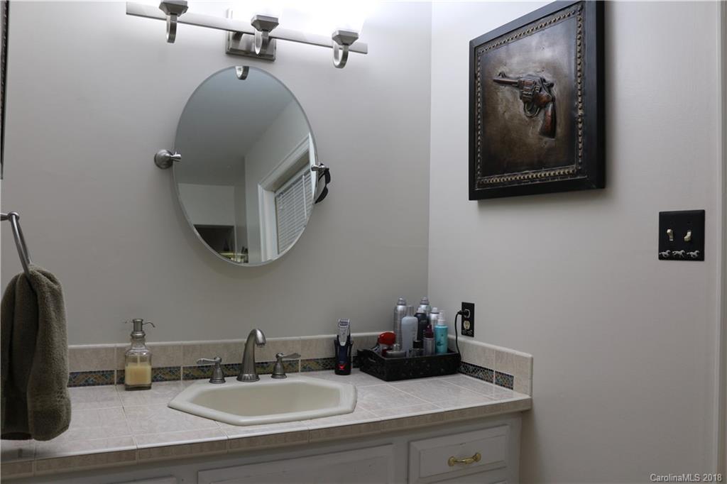 1274 Blacksnake Road Stanley, NC 28164 - Photo 13 of 34 a bathroom with a sink and a mirror