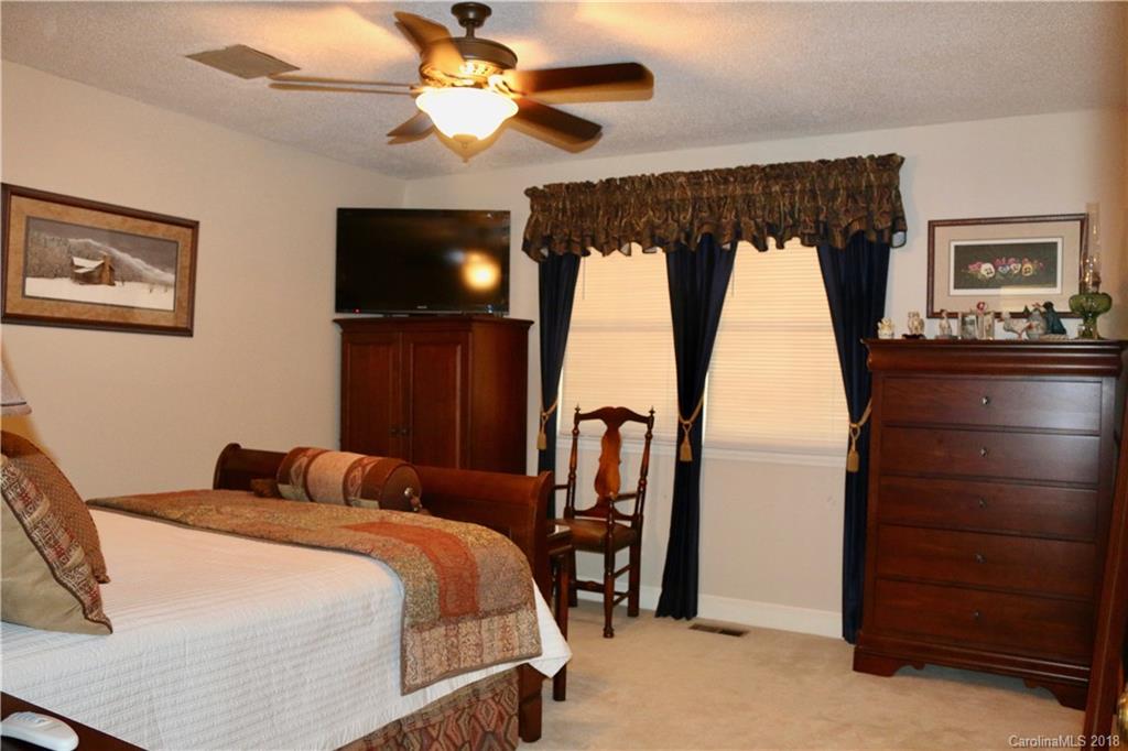 1274 Blacksnake Road Stanley, NC 28164 - Photo 14 of 34 a bedroom with a bed and a television
