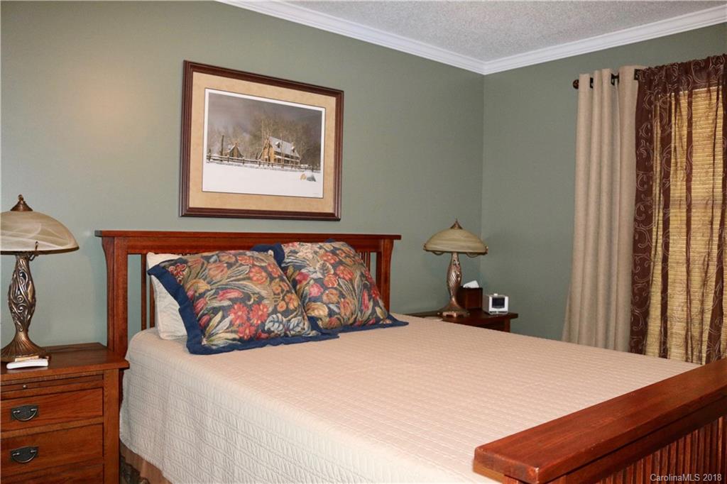 1274 Blacksnake Road Stanley, NC 28164 - Photo 15 of 34 a bedroom with a bed and a painting on the wall
