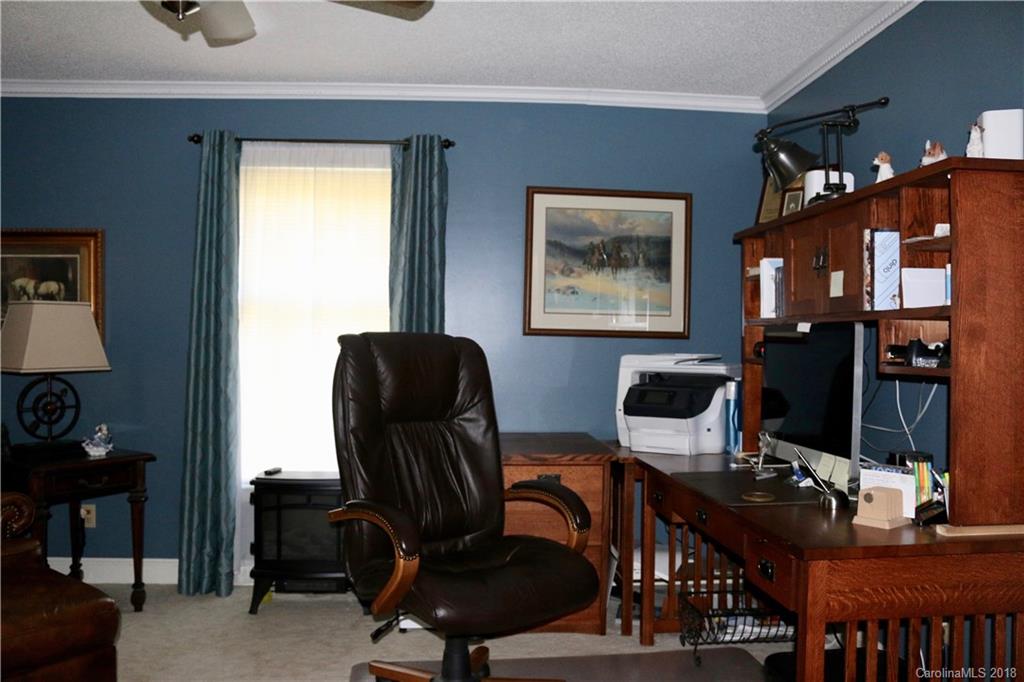 1274 Blacksnake Road Stanley, NC 28164 - Photo 16 of 34 a view of a workspace with furniture and a window