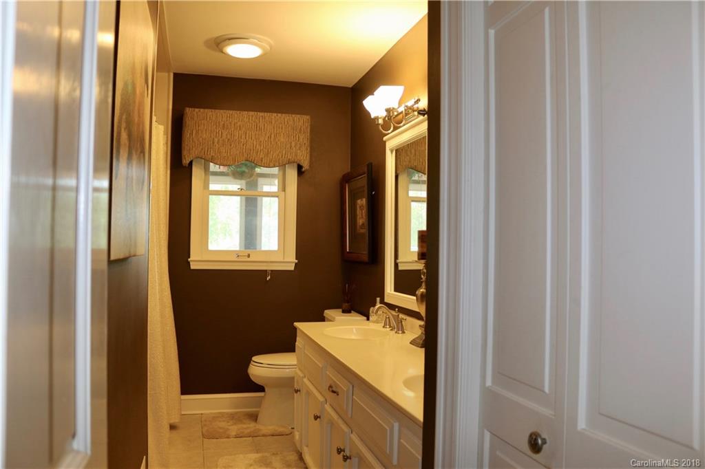 1274 Blacksnake Road Stanley, NC 28164 - Photo 17 of 34 a bathroom with a sink a toilet and shower