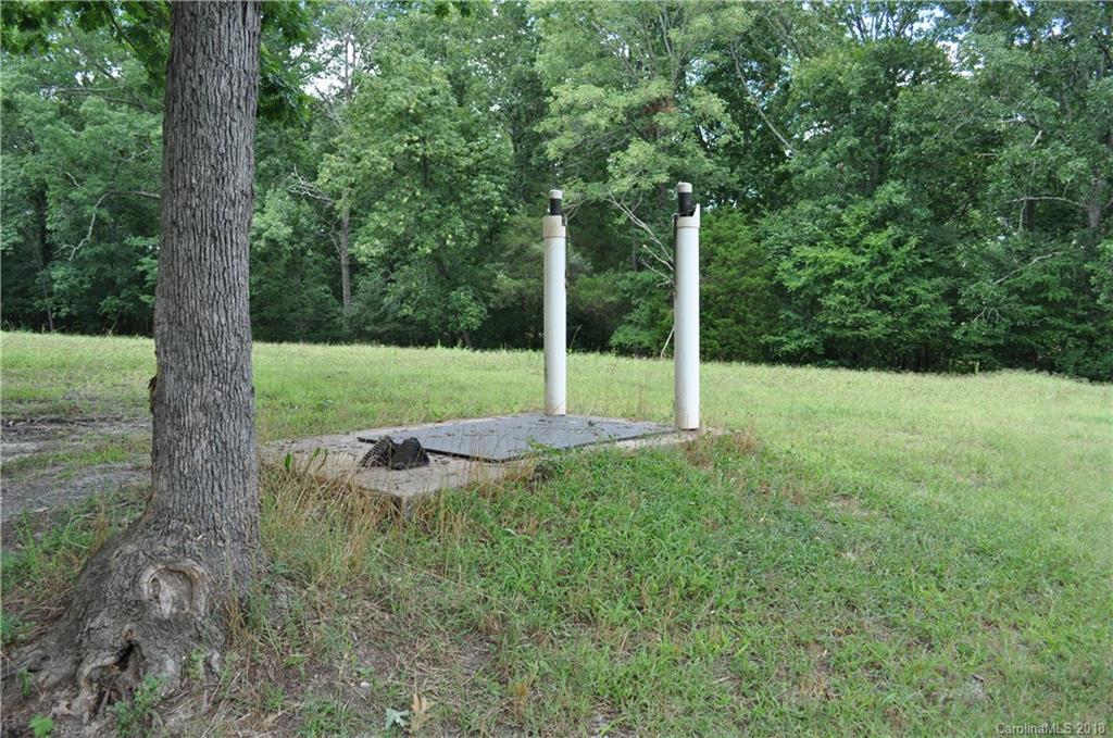 1274 Blacksnake Road Stanley, NC 28164 - Photo 25 of 34 a view of a wooden deck with a tree