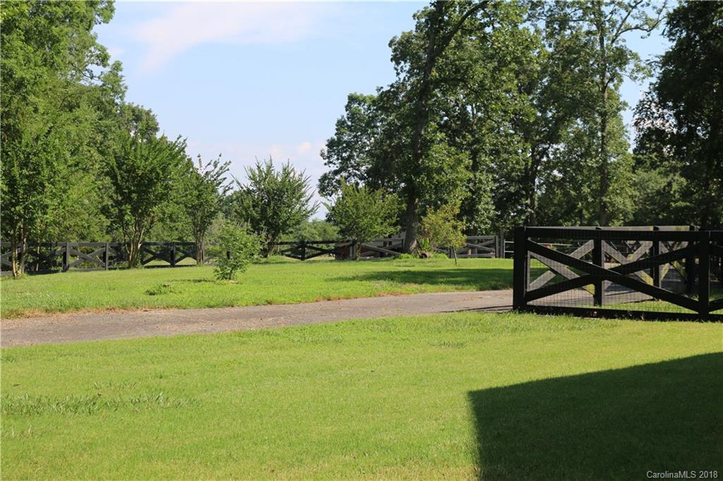 1274 Blacksnake Road Stanley, NC 28164 - Photo 27 of 34 a view of a green field with wooden fence