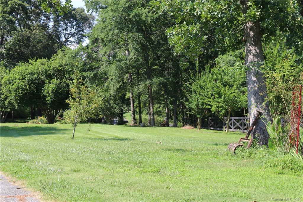 1274 Blacksnake Road Stanley, NC 28164 - Photo 28 of 34 a backyard of a house with lots of green space