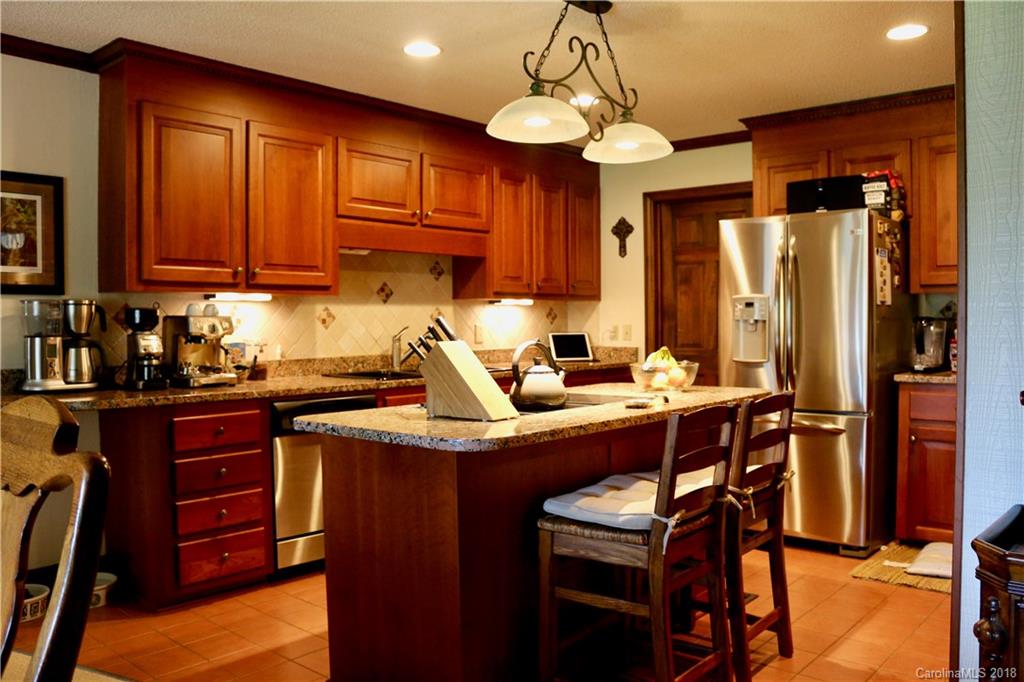 1274 Blacksnake Road Stanley, NC 28164 - Photo 5 of 34 a room with stainless steel appliances kitchen island granite countertop a table chairs in it and a window