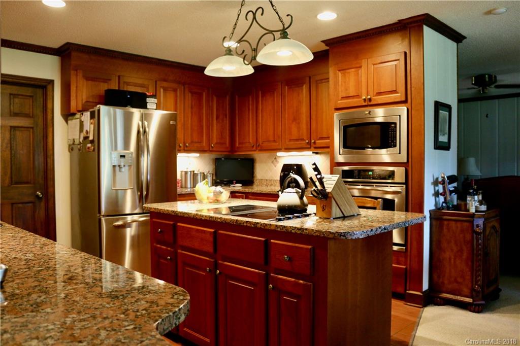 1274 Blacksnake Road Stanley, NC 28164 - Photo 6 of 34 a kitchen with stainless steel appliances granite countertop a refrigerator stove top oven a sink and dishwasher