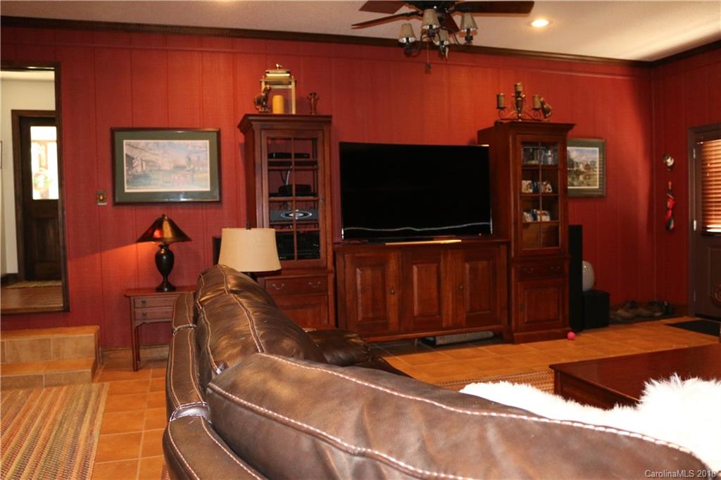 1274 Blacksnake Road Stanley, NC 28164 - Photo 9 of 34 a living room with furniture and a flat screen tv