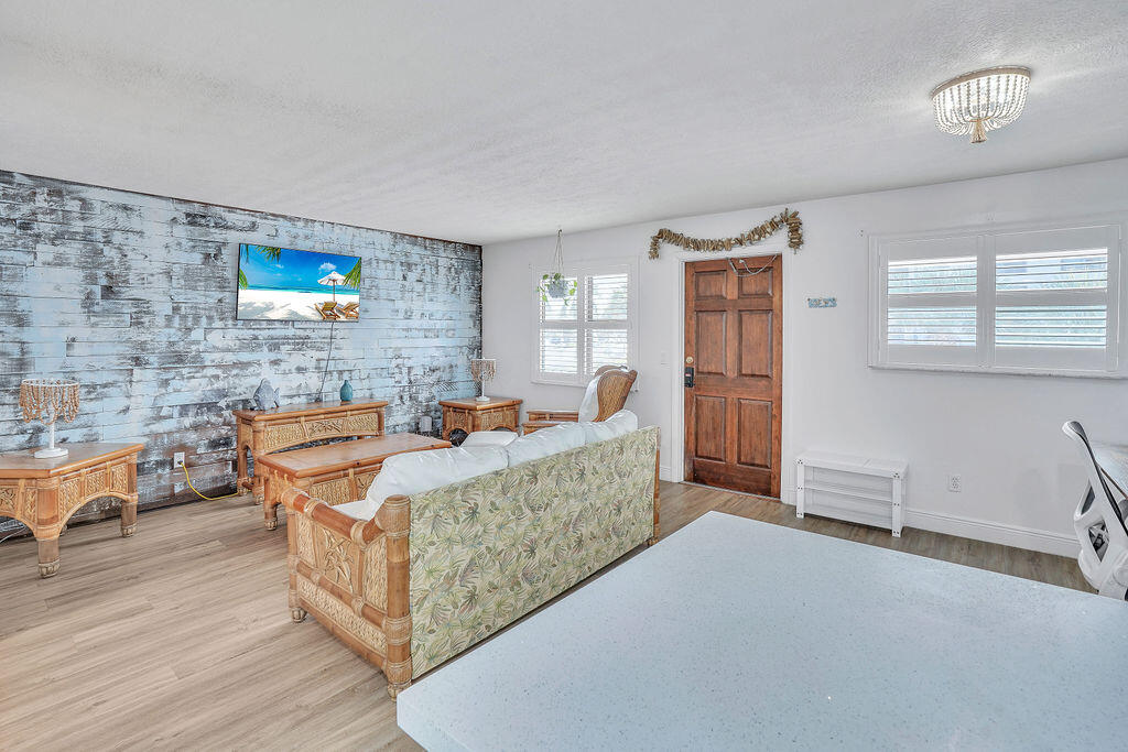 715 South Ocean Drive, Unit G Fort Pierce, FL 34949 - Photo 12 of 24 a living room with furniture and a wooden floor
