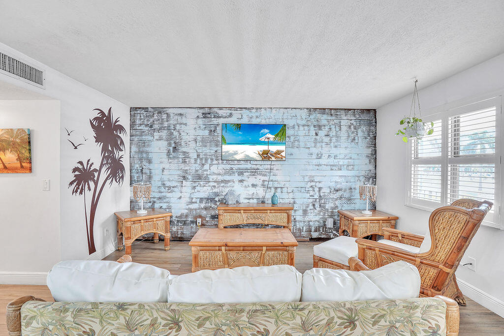 715 South Ocean Drive, Unit G Fort Pierce, FL 34949 - Photo 17 of 24 a living room with furniture and a flat screen tv