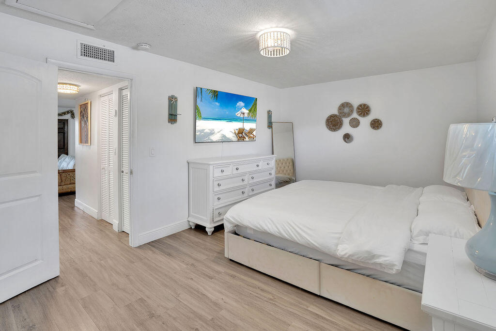 715 South Ocean Drive, Unit G Fort Pierce, FL 34949 - Photo 22 of 24 a bedroom with a bed and a window