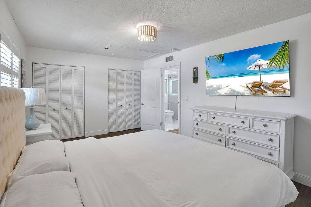 715 South Ocean Drive, Unit G Fort Pierce, FL 34949 - Photo 24 of 24 a bedroom with a bed and a flat screen tv