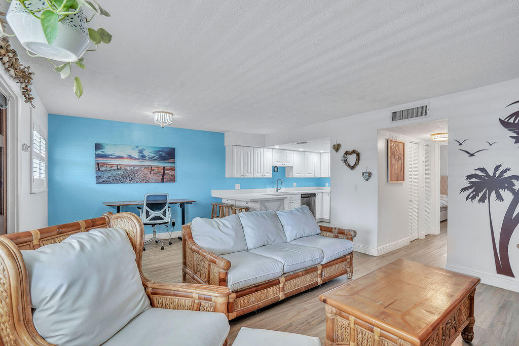 715 South Ocean Drive, Unit G Fort Pierce, FL 34949 - Photo 10 of 24 a living room with furniture and a chandelier