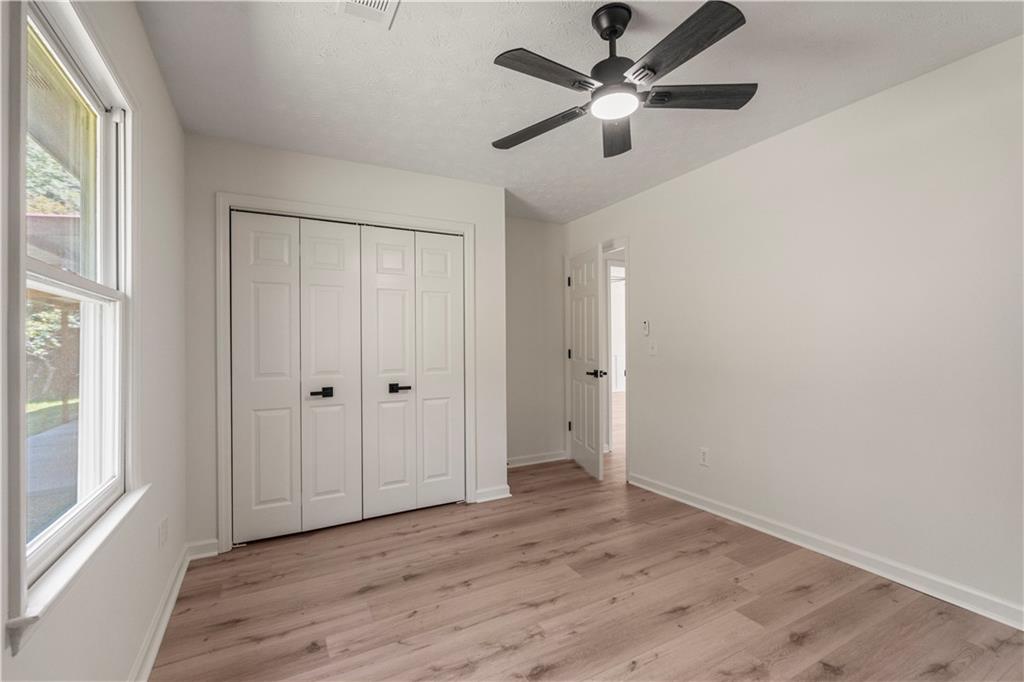 766 Lee Road Phenix City, AL 36870 - Photo 18 of 30 Unfurnished bedroom with light wood-type flooring, a closet, and ceiling fan