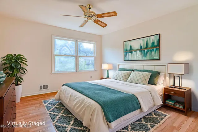 a bedroom with a bed and a painting on the wall