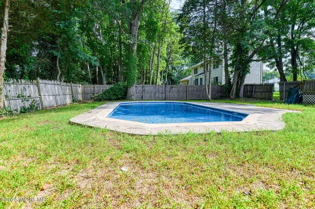 a view of a backyard with swimming pool