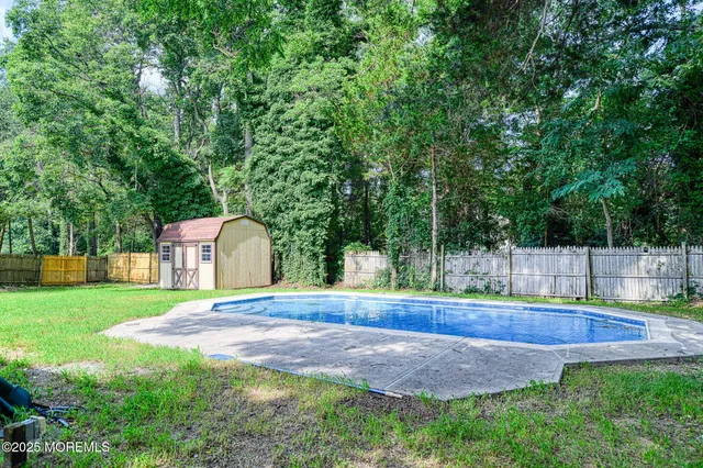 a backyard of a house with lots of green space and fountain