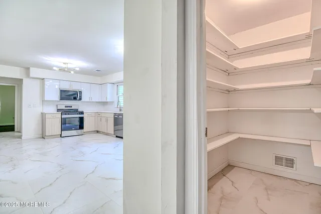 a dining room with furniture a chandelier and wooden floor