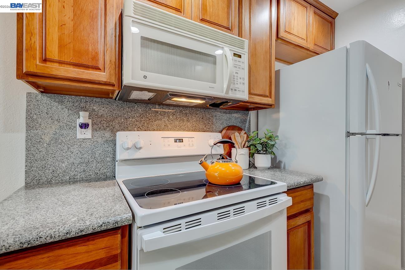 9005 Alcosta Boulevard, Unit 199 San Ramon, CA 94583 - Photo 28 of 57 a kitchen with a sink a stove and cabinets