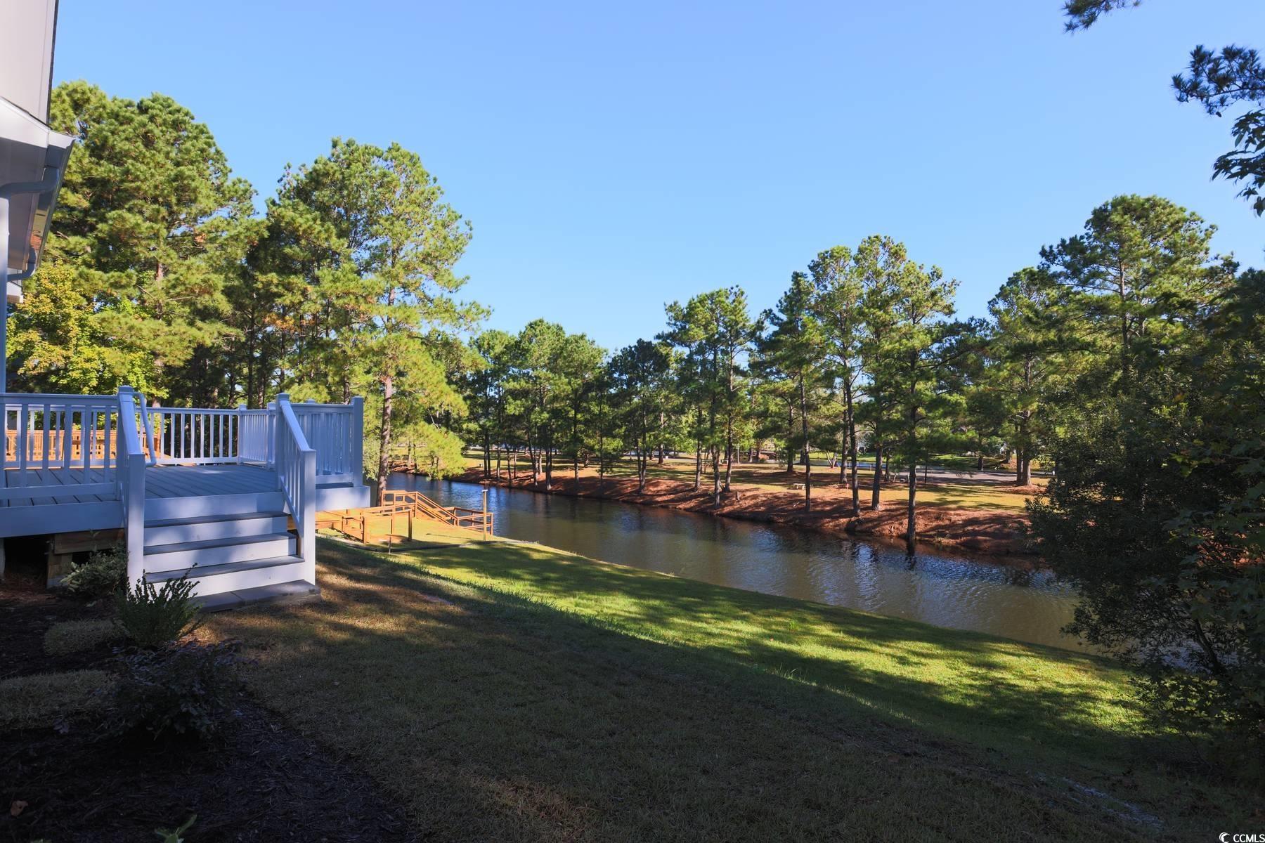 4183 Golf Avenue Little River, SC 29566 - Photo 4 of 39 View of grassy yard featuring a deck with water view