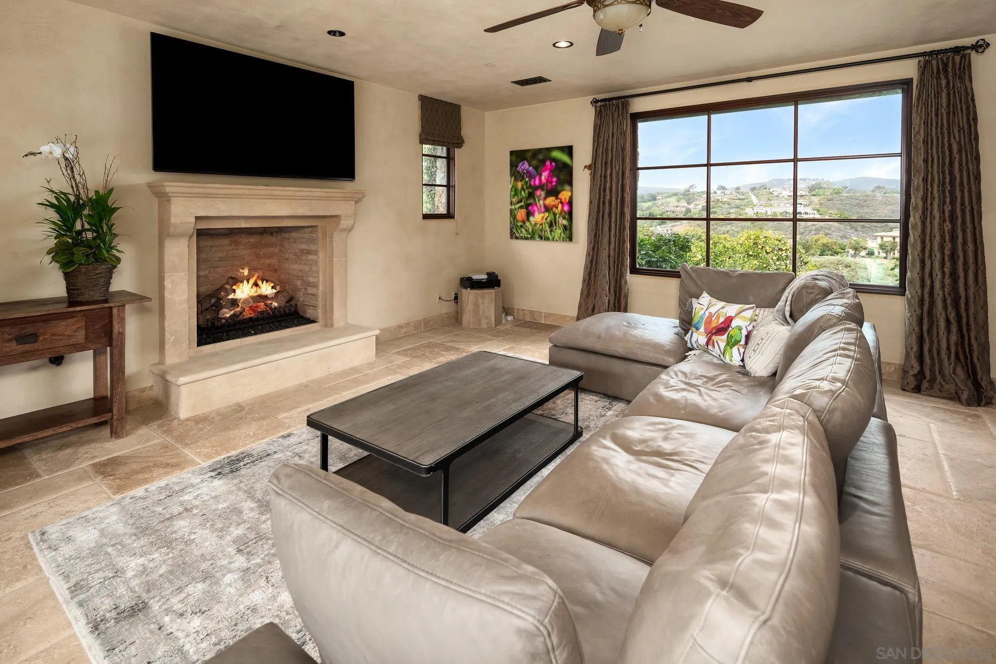 6309 Strada Fragante Rancho Santa Fe, CA 92091 - Photo 45 of 49 a living room with furniture a flat screen tv and a fireplace