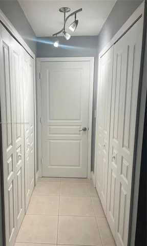 a view of a hallway with entryway window and front door