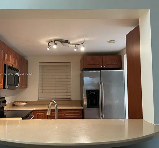 a kitchen with a sink and a refrigerator