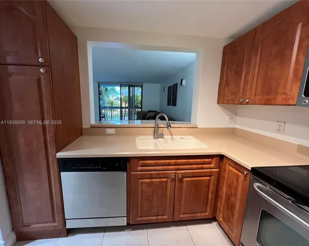 a kitchen with a sink and a refrigerator