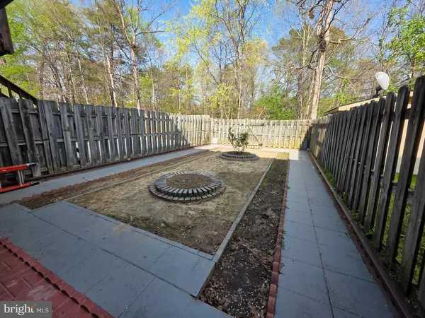 a view of a backyard with wooden fence