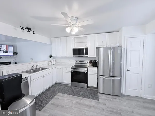 a kitchen with a sink stove and microwave