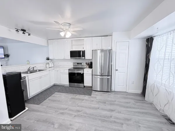 a kitchen with a refrigerator stove and microwave