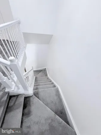 a view of a hallway with wooden floor and closet