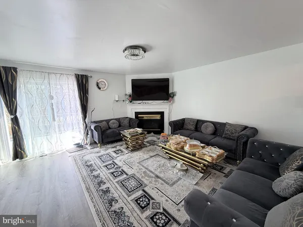 a living room with furniture flat screen tv and a fireplace