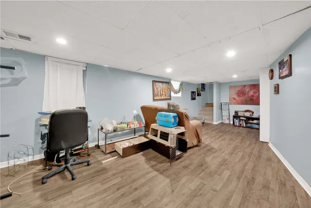 a living room with furniture and a desk