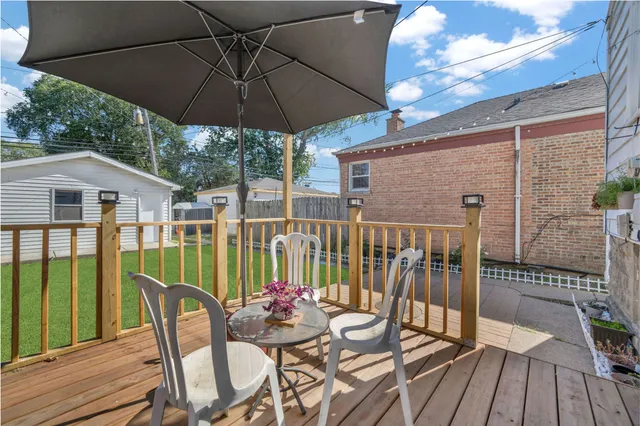 a view of balcony with furniture and umbrella