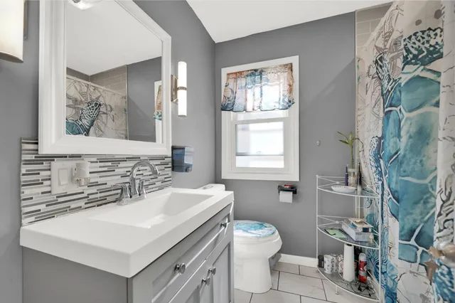 a bathroom with a sink toilet and mirror