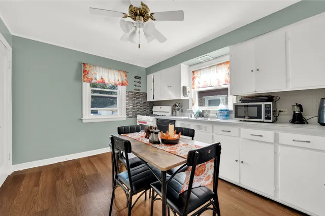 a kitchen with stainless steel appliances a microwave a stove and white cabinets
