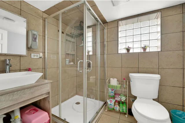 a white toilet sitting next to a bathroom sink