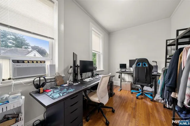 a view of a workspace with furniture and a window