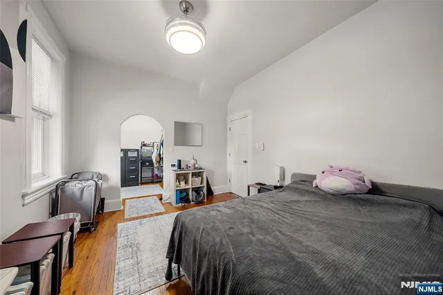 a bedroom with furniture and a book shelf