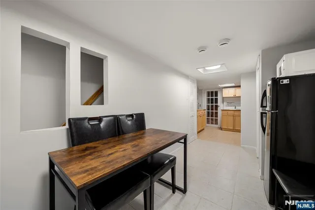 a living room with a couch and a refrigerator