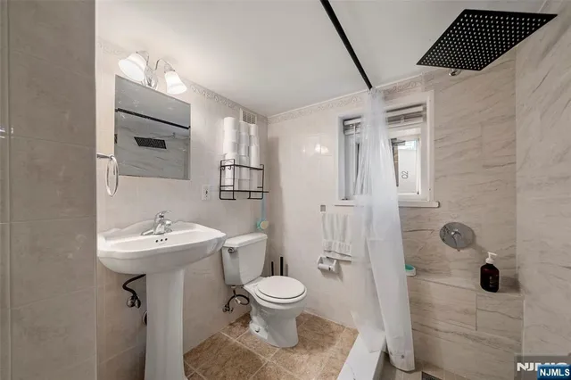 a bathroom with a toilet sink and shower