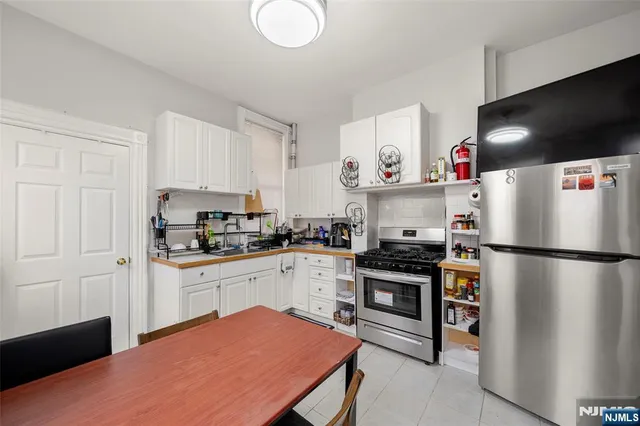 a kitchen with stainless steel appliances a refrigerator stove microwave and cabinets