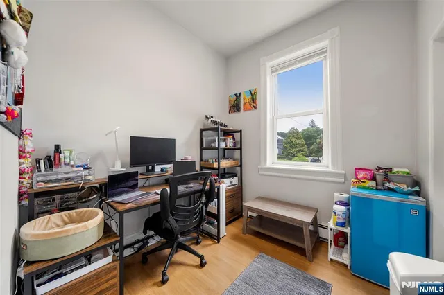 a view of a workspace with furniture and a window