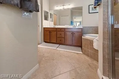 a bathroom with a granite countertop sink a toilet and bathtub