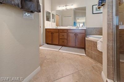9844 Venezia Circle, Unit 721 Naples, FL 34113 - Photo 12 of 50 a bathroom with a granite countertop sink a toilet and bathtub