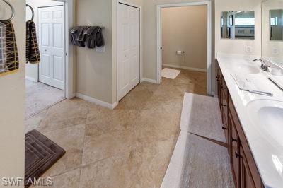 9844 Venezia Circle, Unit 721 Naples, FL 34113 - Photo 14 of 50 a view of a walk in closet and bedroom