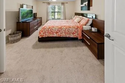 a bedroom with a bed and flat screen tv