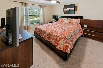 9844 Venezia Circle, Unit 721 Naples, FL 34113 - Photo 16 of 50 a bed sitting in a bedroom next to a window