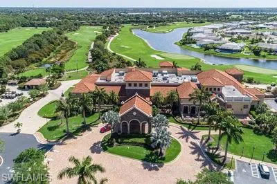 an aerial view of a house with outdoor space and lake view