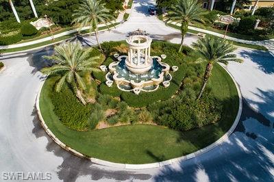 9844 Venezia Circle, Unit 721 Naples, FL 34113 - Photo 49 of 50 a view of a swimming pool with a vase of flowers
